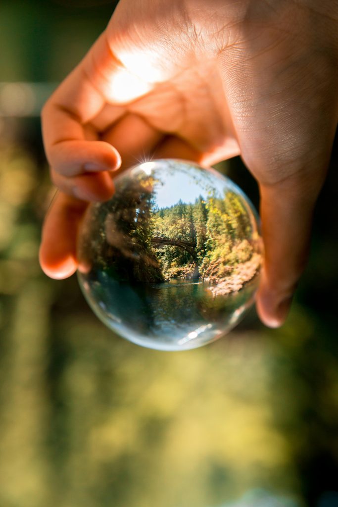 Person holding clear glass ball