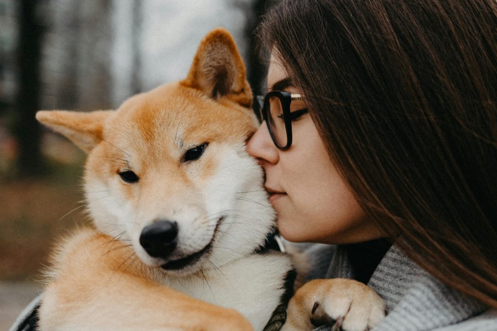 women self care snuggle with dog