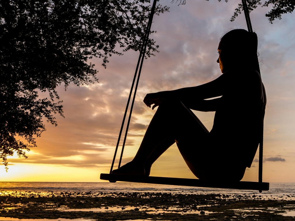women thinking on a swing
