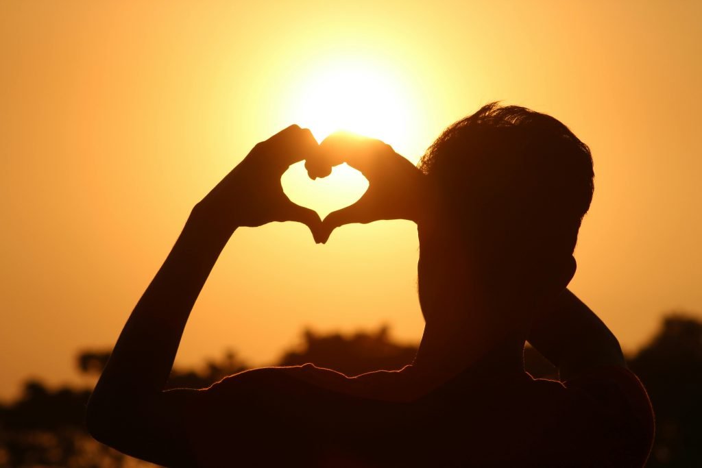Person making heart symbol
